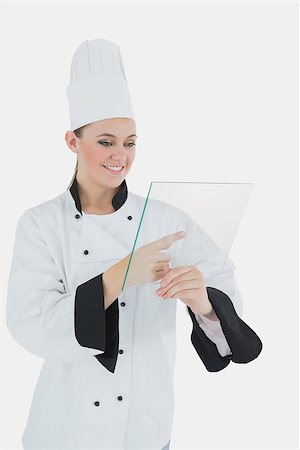 Happy young female chef with glass tablet over white background Stock Photo - Budget Royalty-Free & Subscription, Code: 400-06868730