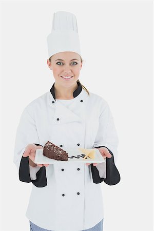 pastry chef uniform for women - Portrait of happy female chef holding pastry plate over white background Stock Photo - Budget Royalty-Free & Subscription, Code: 400-06868771