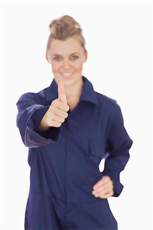 Portrait of young female technician gesturing thumbs up over white background Stockbilder - Microstock & Abonnement, Bildnummer: 400-06868899