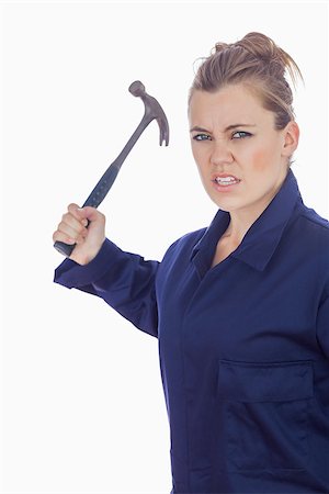 Portrait of an angry female mechanic holding claw hammer against white background Stockbilder - Microstock & Abonnement, Bildnummer: 400-06868891