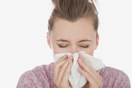 simsearch:400-06868935,k - Closeup of young woman suffering from cold against white background Foto de stock - Super Valor sin royalties y Suscripción, Código: 400-06868922