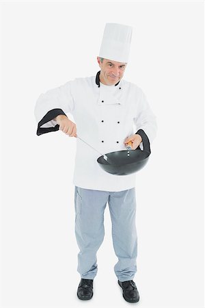 Full length portrait of confident male chef cooking food over white background Stock Photo - Budget Royalty-Free & Subscription, Code: 400-06869077