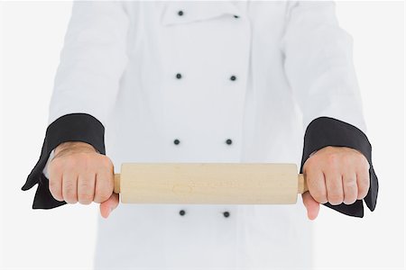 rolling over - Chef using rolling pin over white background Stock Photo - Budget Royalty-Free & Subscription, Code: 400-06869088