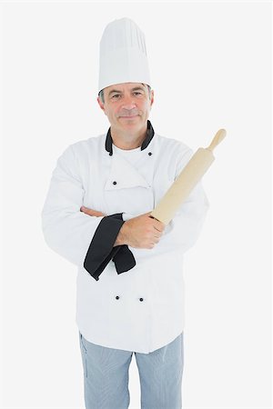 rolling over - Portrait of confident male chef holding rolling pin over white background Stock Photo - Budget Royalty-Free & Subscription, Code: 400-06869081