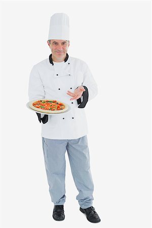 Full length portrait of male chef displaying pizza over white background Stock Photo - Budget Royalty-Free & Subscription, Code: 400-06869124