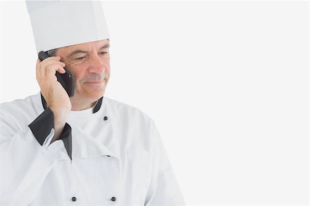 Male chef on call standing against white background Photographie de stock - Aubaine LD & Abonnement, Code: 400-06869178