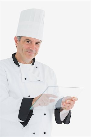 simsearch:400-07468062,k - Portrait of happy male chef using glass tablet against white background Stockbilder - Microstock & Abonnement, Bildnummer: 400-06869184