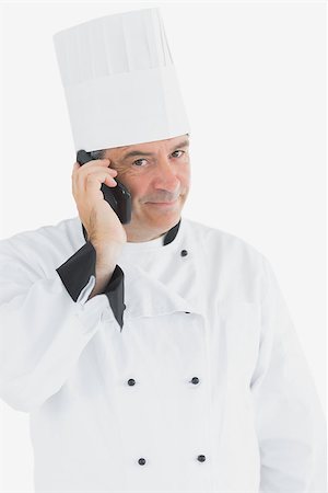 Portrait of male chef on call standing against white background Photographie de stock - Aubaine LD & Abonnement, Code: 400-06869180