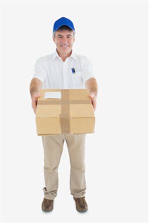Portrait of mature delivery man handing package against white background Stock Photo - Budget Royalty-Free & Subscription, Code: 400-06869195