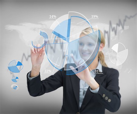 simsearch:400-06802290,k - Smiling businesswoman using graphs on touch screen Stock Photo - Budget Royalty-Free & Subscription, Code: 400-06869586