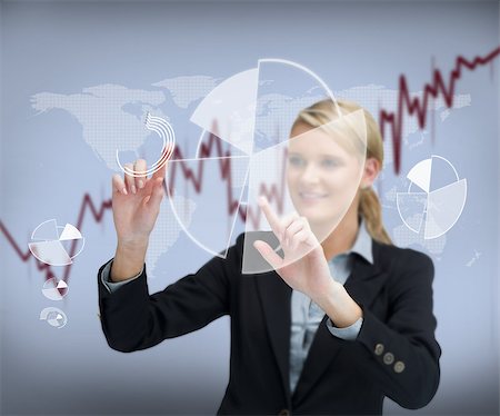 simsearch:400-06802290,k - Smiling businesswoman touching graphs on the screen Stock Photo - Budget Royalty-Free & Subscription, Code: 400-06869594