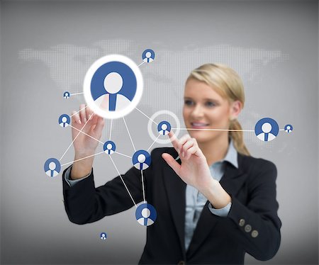 simsearch:400-06802290,k - Smiling businesswoman standing before touch screen with contacts Stock Photo - Budget Royalty-Free & Subscription, Code: 400-06869590