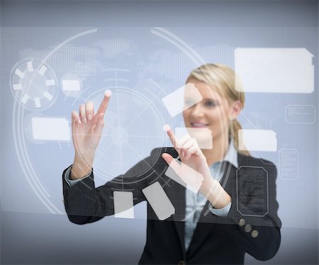 simsearch:400-06802290,k - Smiling businesswomans finger touching screen against a grey background Stock Photo - Budget Royalty-Free & Subscription, Code: 400-06869592