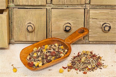 simsearch:400-06880681,k - organic herbal tea (chamomile, peppermint,,orange peel, rose hips, hibiscus,) - rustic wooden scoop and a pile on rough white painted barn wood with a primitive apothecary drawer cabinet Stock Photo - Budget Royalty-Free & Subscription, Code: 400-06869836