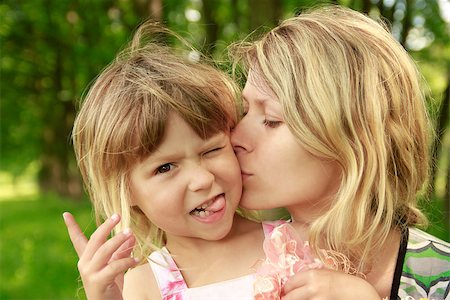 Mama and her little daughter playing on grass Stock Photo - Budget Royalty-Free & Subscription, Code: 400-06860052