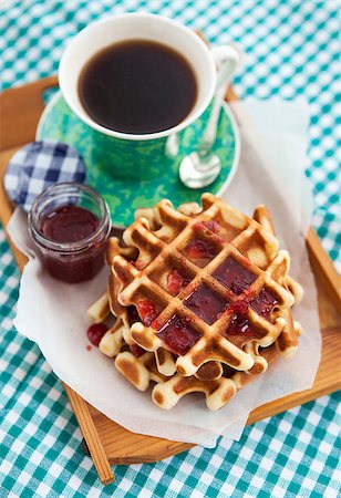 Breakfast with belgian waffles with jam and coffee on the tray on the checkered tablecloth, top view Foto de stock - Super Valor sin royalties y Suscripción, Código: 400-06860082