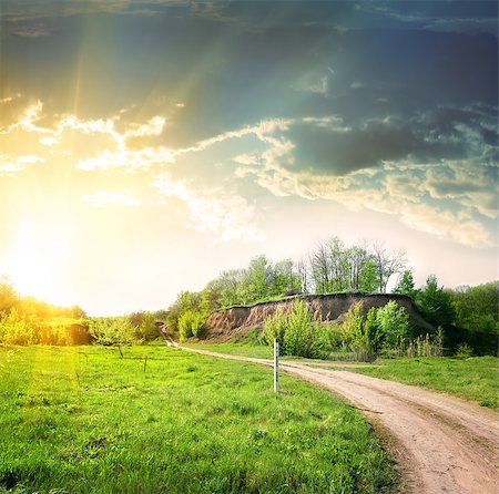 Country road and a break in the rays of the evening sun Stock Photo - Budget Royalty-Free & Subscription, Code: 400-06860151