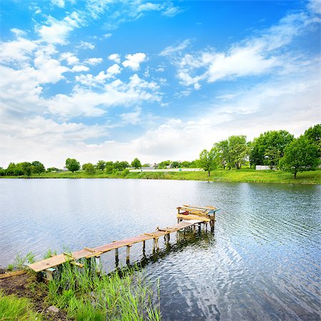 Wooden dock, pier, on a lake in summer sunny day Stock Photo - Budget Royalty-Free & Subscription, Code: 400-06860166