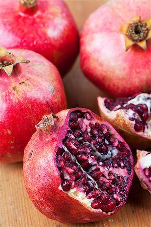 Four pomegranate on wooden surface, one cut open Stock Photo - Budget Royalty-Free & Subscription, Code: 400-06860182