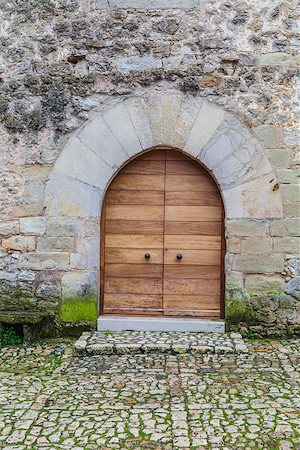 Ancient wooden door with stone frame Stock Photo - Budget Royalty-Free & Subscription, Code: 400-06860213