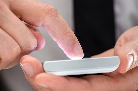 Detail of a man using turned on touchscreen phone. Stockbilder - Microstock & Abonnement, Bildnummer: 400-06860334