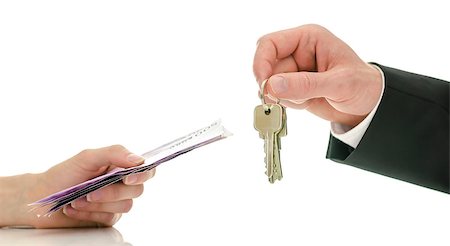 simsearch:400-06855814,k - Closeup of male hand giving house keys to a woman in exchange for money. Concept of final step in purchasing a new house. Foto de stock - Royalty-Free Super Valor e Assinatura, Número: 400-06860353