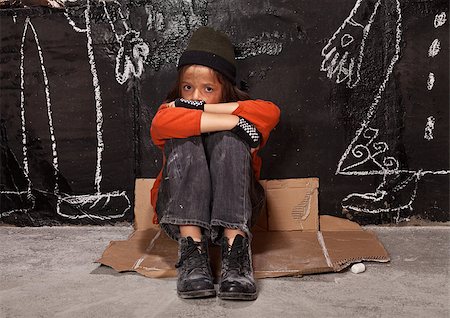 sad lonely boy pictures - Orphan child on the street concept - boy sitting by the wall with drawn parent figures Stock Photo - Budget Royalty-Free & Subscription, Code: 400-06860469