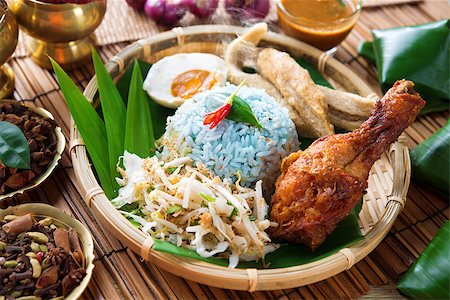 fried chicken with banana - Nasi kerabu or nasi ulam, popular Malay rice dish. Blue color of rice resulting from the petals of  butterfly-pea flowers. Traditional Malaysian food, Asian cuisine. Stock Photo - Budget Royalty-Free & Subscription, Code: 400-06860654