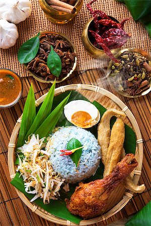 fried chicken with banana - Traditional Malaysian food, Asian cuisine. Nasi kerabu is a type of nasi ulam, popular Malay rice dish. Blue color of rice resulting from the petals of  butterfly-pea flowers Stock Photo - Budget Royalty-Free & Subscription, Code: 400-06860655