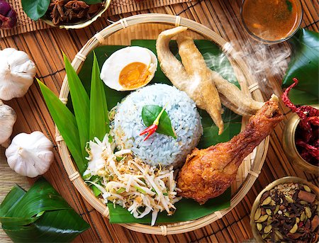 fried chicken with banana - Nasi kerabu is a type of nasi ulam, popular Malay rice dish. Blue color of rice resulting from the petals of  butterfly-pea flowers. Traditional Malaysian food, Asian cuisine. Stock Photo - Budget Royalty-Free & Subscription, Code: 400-06860653