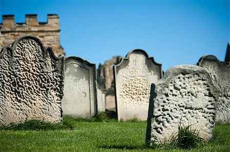 simsearch:400-06177063,k - Old weathered gravestones arranged haphazardly on green grass, closeup view against a blue sky Foto de stock - Royalty-Free Super Valor e Assinatura, Número: 400-06861202