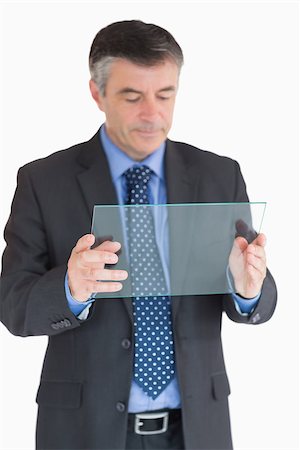 slide business man - Businessman holding a glass slide and viewing it Stock Photo - Budget Royalty-Free & Subscription, Code: 400-06862598