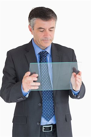 slide business man - Businessman looking at clear pane in his hands Stock Photo - Budget Royalty-Free & Subscription, Code: 400-06862599