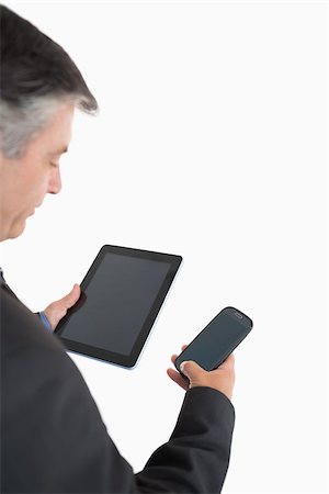 simsearch:400-07141016,k - Businessman holding tablet pc and mobile phone in his hands Stockbilder - Microstock & Abonnement, Bildnummer: 400-06862609