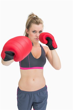 people in ready for fight - Woman standing in boxing gear ready to punch Stock Photo - Budget Royalty-Free & Subscription, Code: 400-06862958