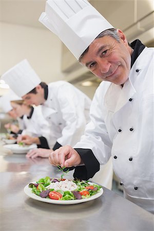 simsearch:400-06863053,k - Cheerful Chef's preparing their salads in the kitchen Stockbilder - Microstock & Abonnement, Bildnummer: 400-06863015