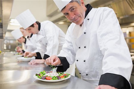 simsearch:400-06863053,k - Smiling Chef's preparing their salads in the kitchen Stockbilder - Microstock & Abonnement, Bildnummer: 400-06863016