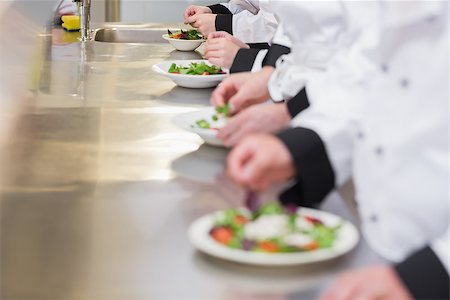 simsearch:400-06863053,k - Chef's preparings salads in a row on a counter Stockbilder - Microstock & Abonnement, Bildnummer: 400-06863039