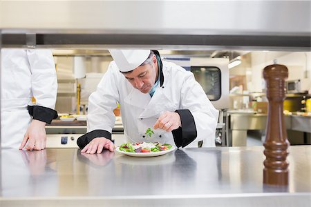 simsearch:400-06863053,k - Chef garnisning his salad in kitchen Stockbilder - Microstock & Abonnement, Bildnummer: 400-06863043