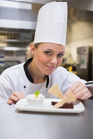 Happy chef finishing desert in the kitchen Stock Photo - Budget Royalty-Free & Subscription, Code: 400-06863122