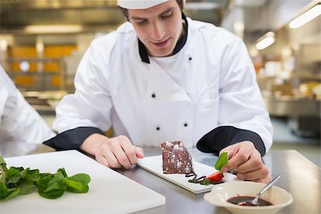 Chef putting mint leaf with his dessert in the kitchen Stock Photo - Budget Royalty-Free & Subscription, Code: 400-06863147