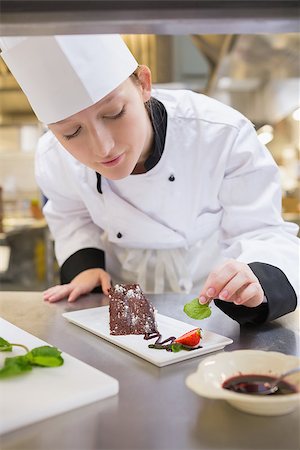 Female chef putting mint with chocolate cake in the kitchen Stock Photo - Budget Royalty-Free & Subscription, Code: 400-06863154