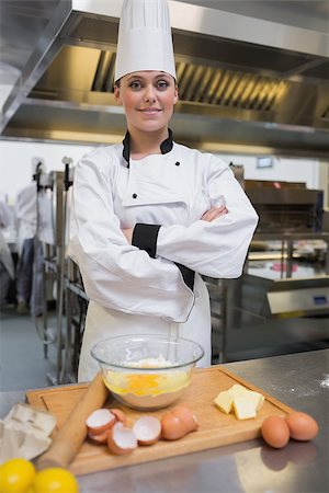 female pastry chef - Smiling pasty chef in the kitchen making dough Stock Photo - Budget Royalty-Free & Subscription, Code: 400-06863246