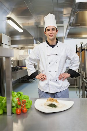 simsearch:400-06863195,k - Chef standing behind his dish in the kitchen and smiling Foto de stock - Super Valor sin royalties y Suscripción, Código: 400-06863267