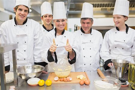 pastry chef uniform for women - Culinary class with pastry teacher giving thumbs up in kitchen Stock Photo - Budget Royalty-Free & Subscription, Code: 400-06863260