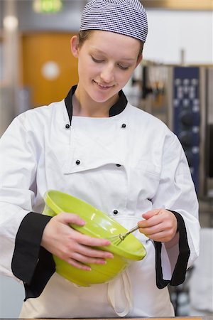 pastry chef uniform for women - Happy baker mixing dough in kitchen Stock Photo - Budget Royalty-Free & Subscription, Code: 400-06863328