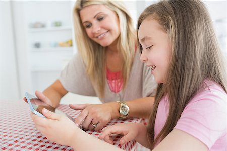 Mother and child holding a tablet computer at the kitchen Stock Photo - Budget Royalty-Free & Subscription, Code: 400-06863503