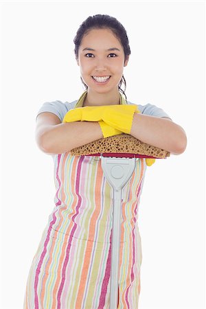 simsearch:400-06863562,k - Smiling woman wearing gloves and apron leaning on mop Stockbilder - Microstock & Abonnement, Bildnummer: 400-06863571