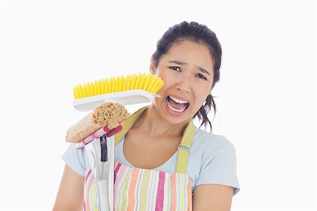 simsearch:400-06863562,k - Frightened woman wearing apron holding mop and a broom Stockbilder - Microstock & Abonnement, Bildnummer: 400-06863572