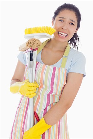 simsearch:400-06863562,k - Distressed woman holding cleaing tools wearing an apron Stockbilder - Microstock & Abonnement, Bildnummer: 400-06863573
